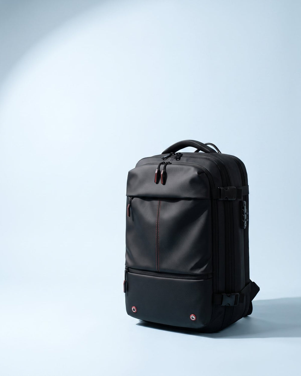 The Atlas backpack seen from the front three-quarter angle on a pale studio stage