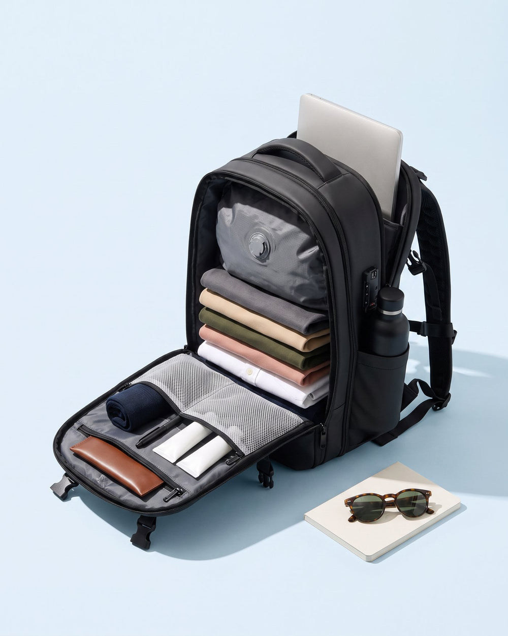 The Atlas packed with clothing in the liner, a laptop in the rear compartment and a bottle in the side pocket