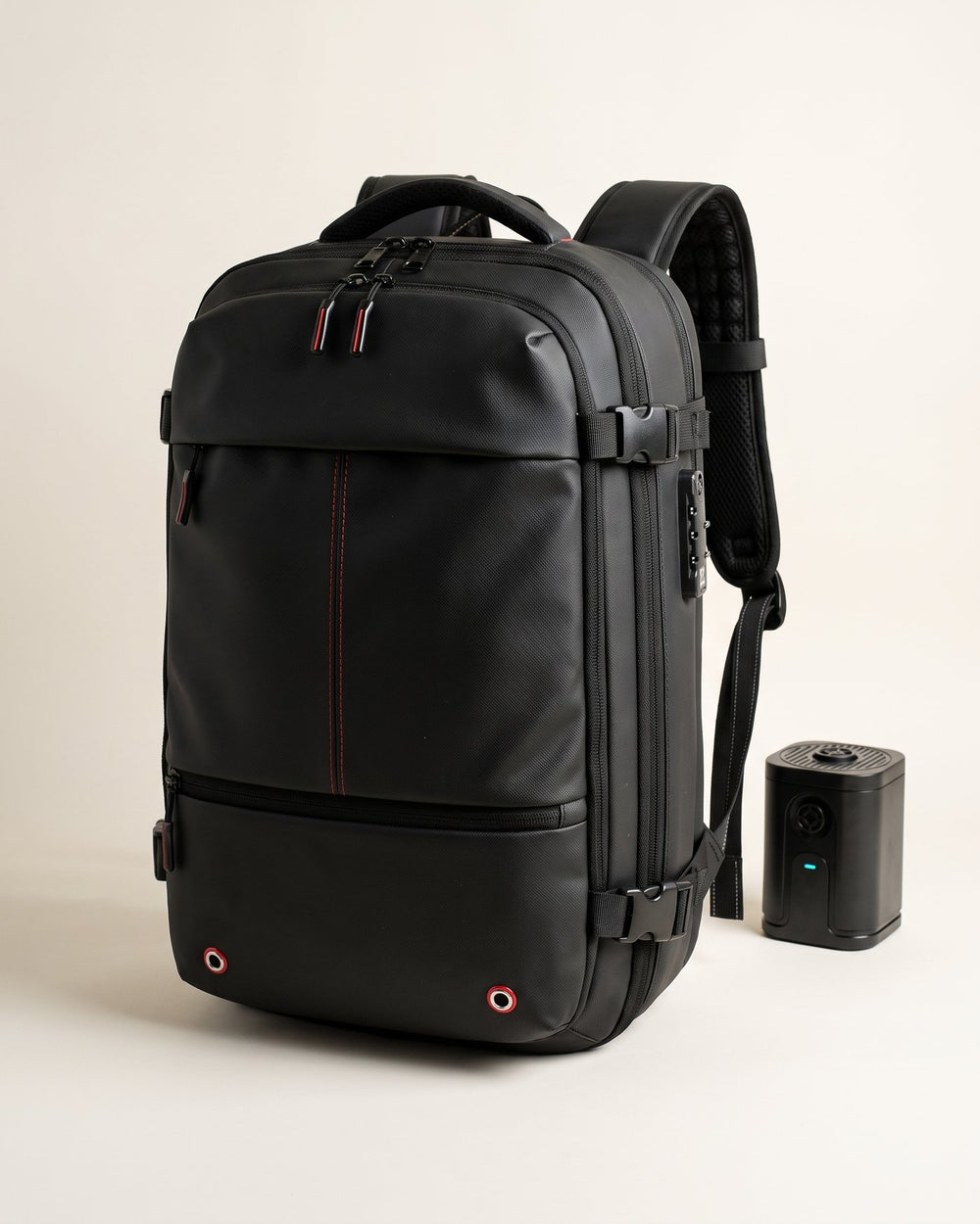 The Atlas backpack and its electric compression pump on a warm studio backdrop